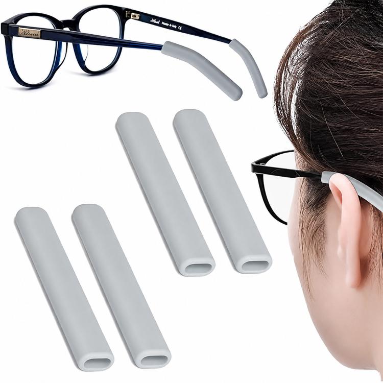Soft silicone eyeglass ear pads, light gray pair shown with eyeglass temple and wearer.