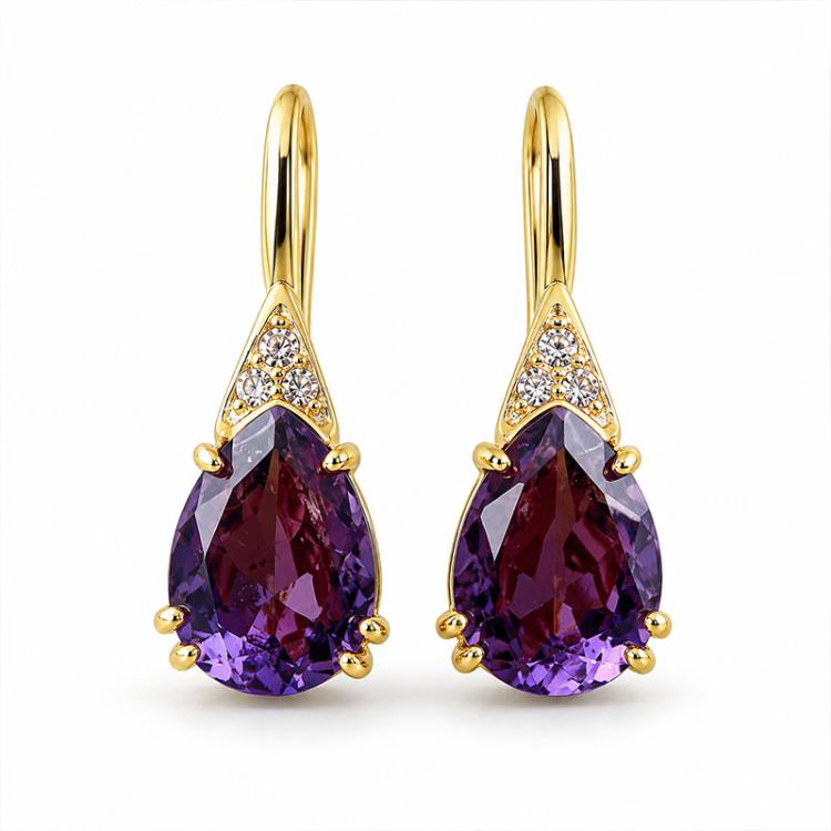 Gold-tone teardrop earrings with faceted purple crystal drops and clear sparkle accents.