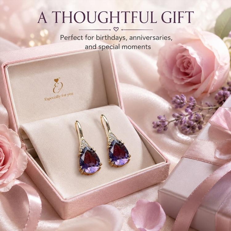 Teardrop dangle earrings in a gift box: gold-tone hooks with purple crystal and clear accents.