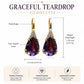 Graceful teardrop earrings with purple pear-shaped stones, gold-tone hooks, and clear accents.