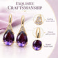 Exquisite gold-tone teardrop earrings with faceted purple crystal drops and clear sparkle stones.