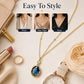 Gold-tone pendant necklace with oval blue stone drop and round clear cap