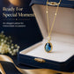 Gold-tone pendant necklace featuring oval blue stone drop with clear top crystal