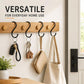 Black iron S hooks on wooden bar, holding keys, key ring, and small bags