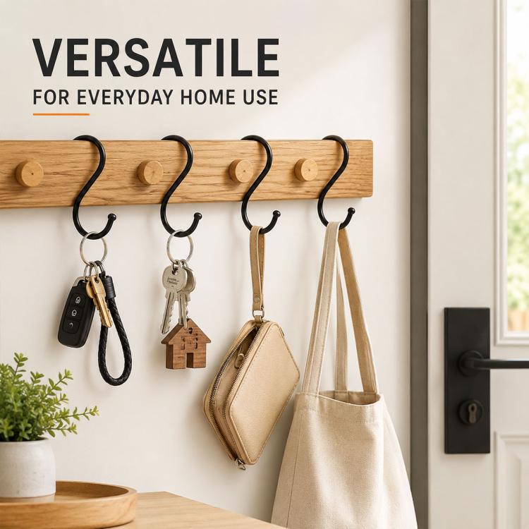 Black iron S hooks on wooden bar, holding keys, key ring, and small bags