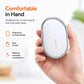 Xiaomi wireless smart tracker tag held in hand, white oval with silver rim