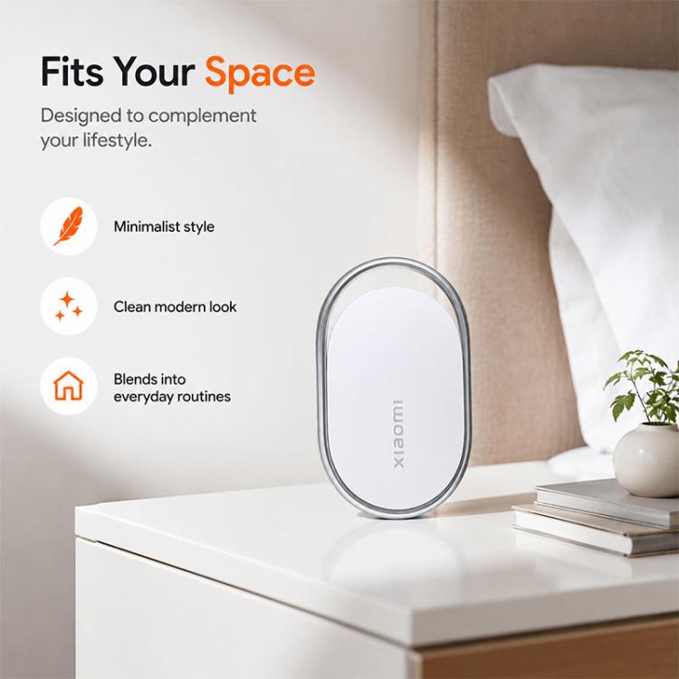 Xiaomi wireless smart tracker tag on nightstand, white oval with silver frame
