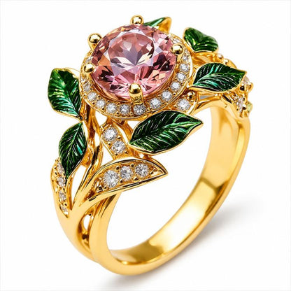 Gold-tone pink gemstone flower ring with green enamel leaves and crystal accents