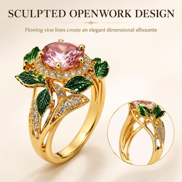 Gold-tone openwork vine-style pink gemstone ring with green enamel leaves and crystals