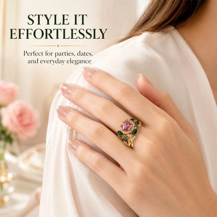 Pink gemstone and green enamel leaf ring worn on finger, gold-tone setting