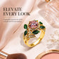 Gold-tone pink center gemstone ring with green enamel leaf motif and crystal details