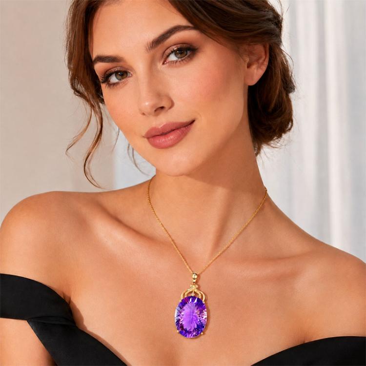 Amethyst pendant necklace with oval purple gemstone on a gold-tone chain