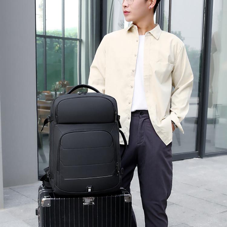 Black business backpack worn by a man, front panel and side straps visible