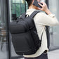 Black waterproof backpack worn on back with padded shoulder straps