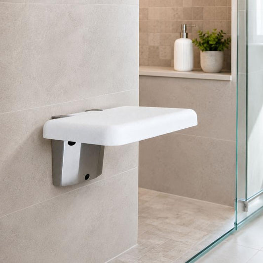 White wall-mounted folding seat with padded top and gray metal bracket