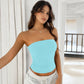 Strapless knitted top in light aqua blue, fitted bodice with curved neckline and cropped hem.