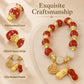 Red bead bracelet with gold-tone coin charm, peanut charm, and white beads