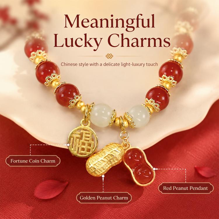 Lucky peanut charm bracelet with red beads, gold pendants, and white center bead