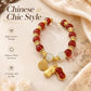 Women’s red peanut charm bracelet with gold-tone charms and white bead spacers