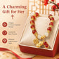 Women’s red bead peanut charm bracelet on gift box with gold-tone coin and peanut charms