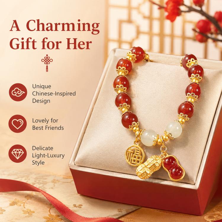 Women’s red bead peanut charm bracelet on gift box with gold-tone coin and peanut charms