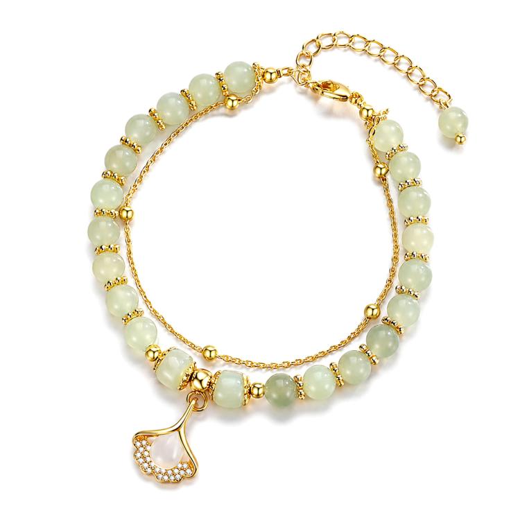 Women’s gold beaded charm bracelet with pale green beads and a teardrop leaf pendant.