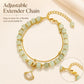 Gold adjustable charm bracelet with pale green beads and a leaf pendant; extender chain shown.