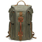 Military green canvas travel backpack with top handle, side zippers, and front utility straps