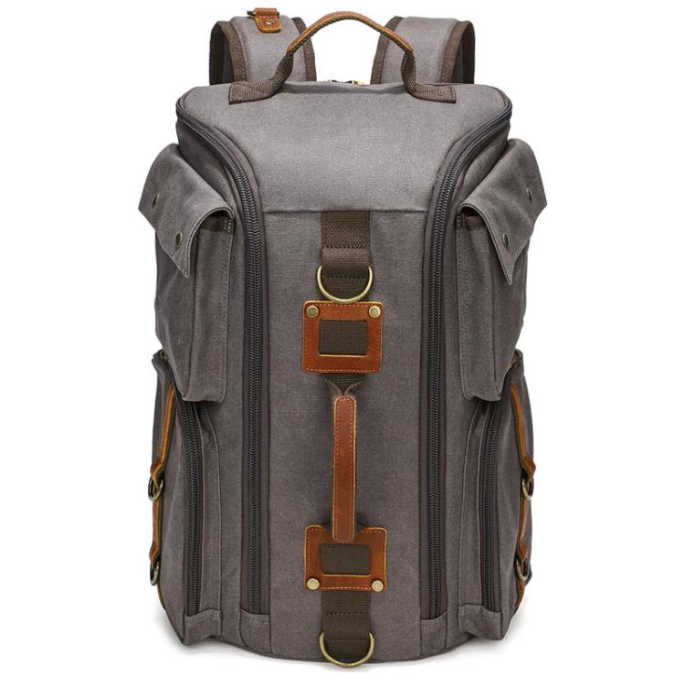 Grey canvas travel backpack with top handle, side zippers, and front leather strap attachments