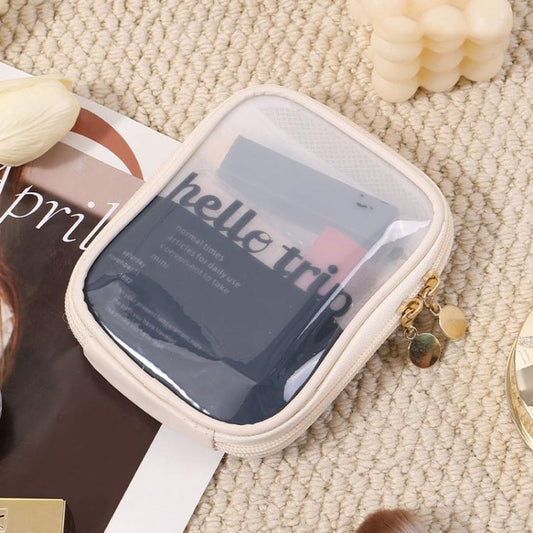 White mini makeup organizer bag with clear front window and zipper closure.