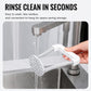 Manual potato masher with white plastic mashing head and metal handle, rinsed under faucet