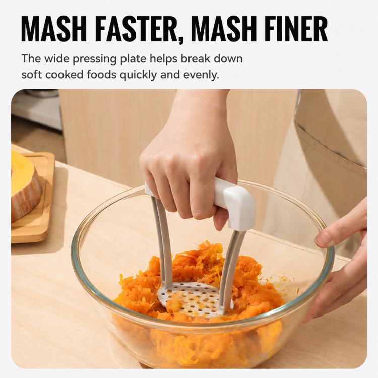 Manual potato masher pressing orange mash in a glass bowl; wide perforated plate