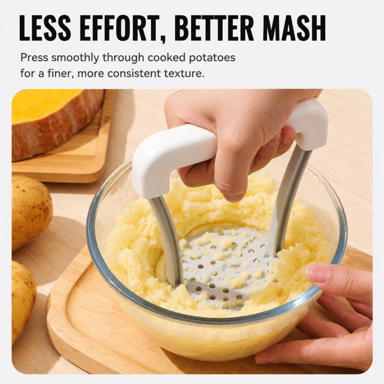 Manual potato masher pressing cooked potatoes in a glass bowl; perforated pressing plate