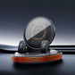 Black phone mount with rotating base and orange LED-style ring, dual side clamps