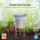 Smart soil sensor standing in soil with blue top cap and two metal probes