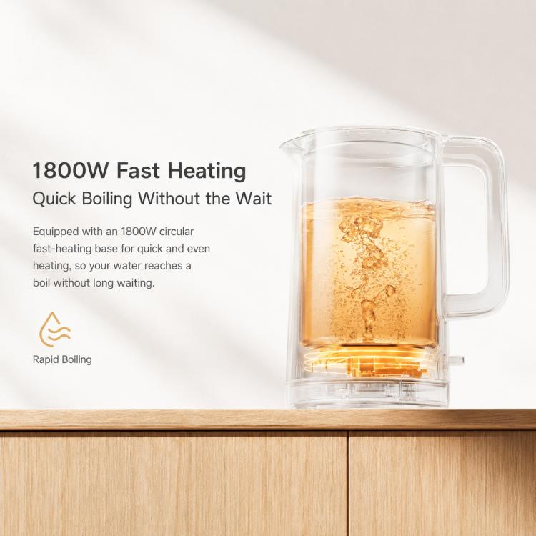 Clear water container electric kettle with amber water and white handle.