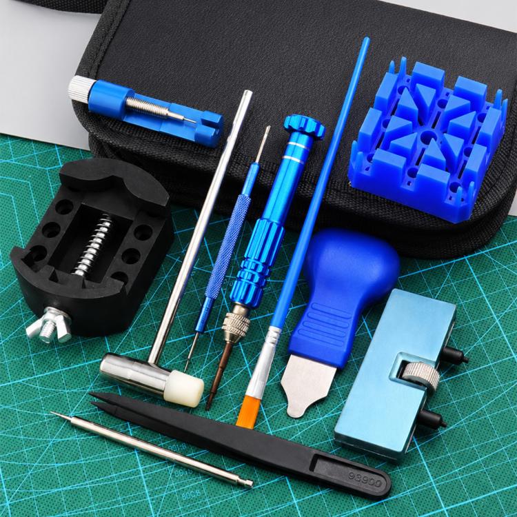 Watch repair tool kit with blue handled tools, metal drivers, and black holder on mat