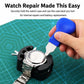 Watch case back pry tool with blue handle and black holder gripping a metal watch