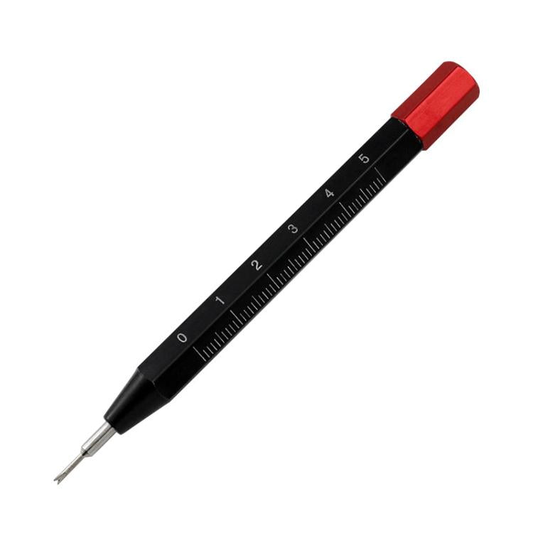 Black spring bar tool with red cap and measurement scale, pointed metal fork tips