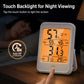 White indoor thermometer and hygrometer with orange backlit display and touch sensor