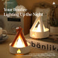 Two campfire night lights—white and orange—glowing with yellow flame light.