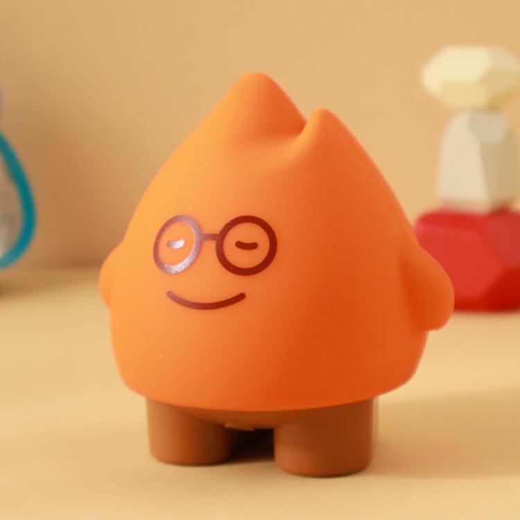 Orange flame night light with cute face, round glasses, and happy smile
