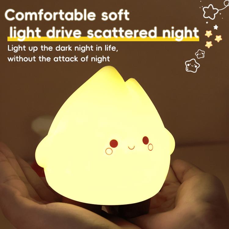 Yellow glowing flame night light with cute face and round cheek dots in hands