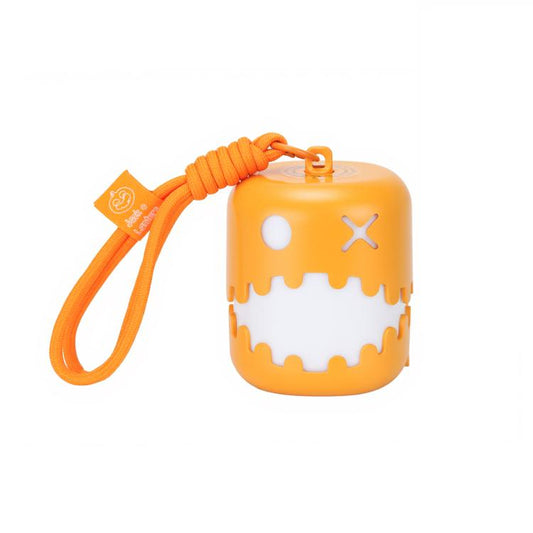 Orange pumpkin lantern night light with jack-o'-lantern face and wrist strap.