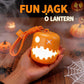 Orange pumpkin lantern night light with glowing jack-o'-lantern face, held in hands.