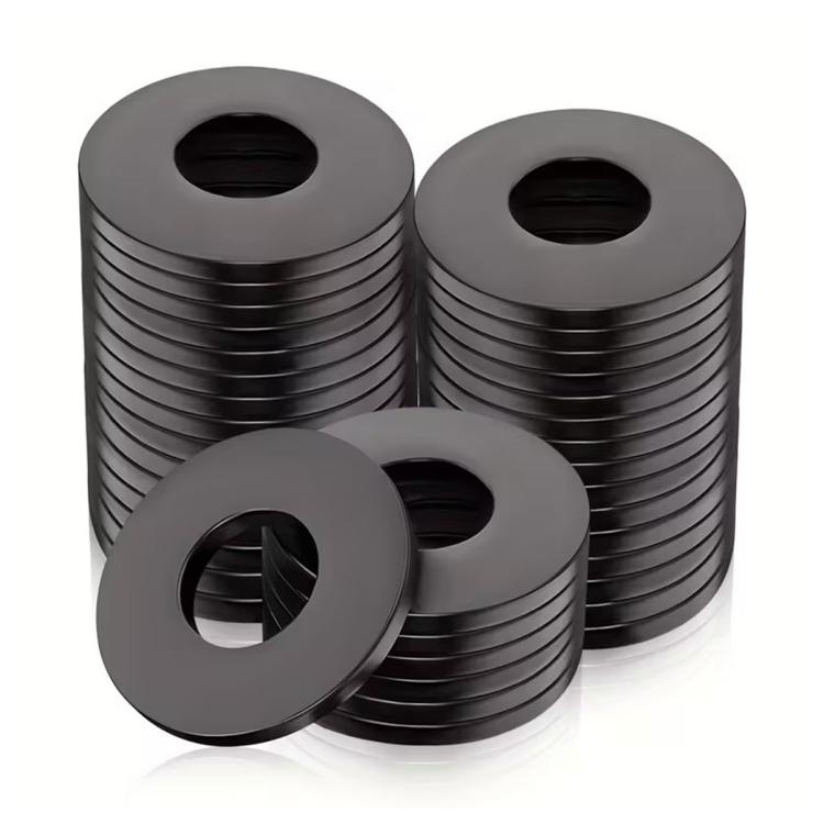 Stacked black round nylon flat washers with center holes, assorted set