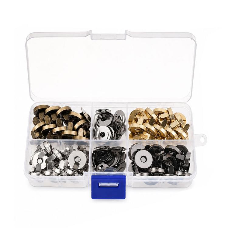 Clear storage box filled with assorted metal magnetic snaps, mixed gold, silver, and black