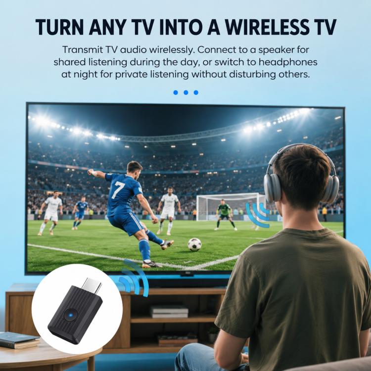 Black wireless Bluetooth audio transmitter adapter near TV and headphones for listening