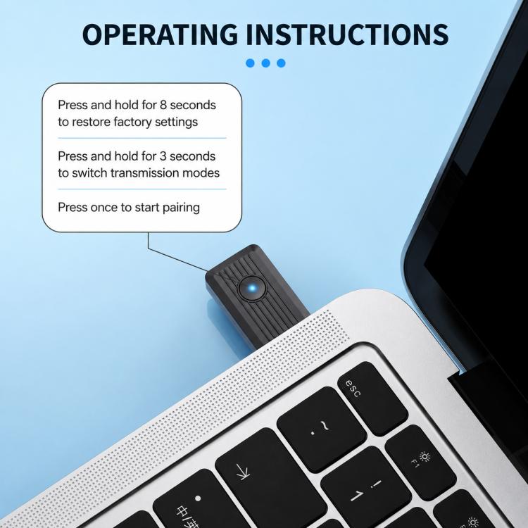 Black wireless Bluetooth audio transmitter adapter with blue light next to keyboard