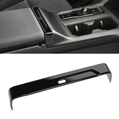 Toyota RAV4 armrest box trim strip in glossy black with center opening detail